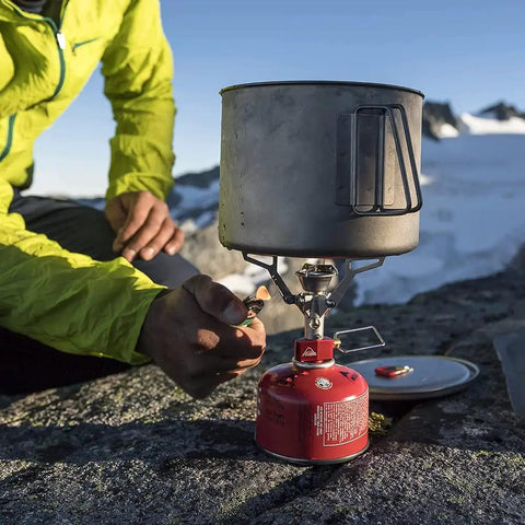 Person lighting the Ultralight Folding Camping Stove That Fits In Your Pocket, Boils 1 Liter In About 3.5 Minutes, Adjustable Flame