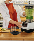 Person using a blender in a kitchen with a Juicer Spout Splash Guard Replacement Part For FS301 And FS300 Vertical Juicers Black