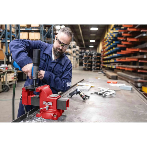 Man using Swivel Bench Vise Six Inch Opening With Three And A Half Inch Throat, 360 Degree Rotating Base With Lock Down in workshop.