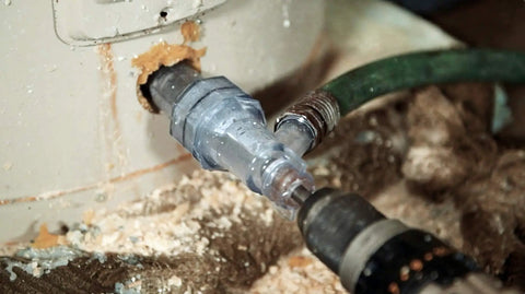 Close-up of Tank Cleaner Water Heater Tool for Quick Flush and Sediment Removal in use with drill and hose attachment.