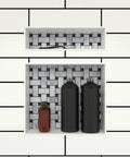 Double Recessed Shower Niche Shelf With Two Shelves 20 Inch High By 16 Inch Wide Black Tile Ready Built In Bathroom Organizer For Soap Shampoo Razors And More installed with black and white tile pattern, holding bottles and a razor.