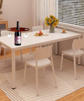 Dining table setup with Two Pack Classic Wine Caddy Router Templates One Quarter Inch Thick Acrylic Carving Jigs displayed holding wine bottle and glasses.