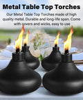 Four metal table top torches with flames lit, placed on an outdoor table, showcasing Two Pack Metal Table Top Torches With 24.5 Ounce Citronella Fuel Capacity Refillable Outdoor Flame Light Lanterns For Patio Deck Garden Party Durable Decorative Torch Lights For Yard Ambience.