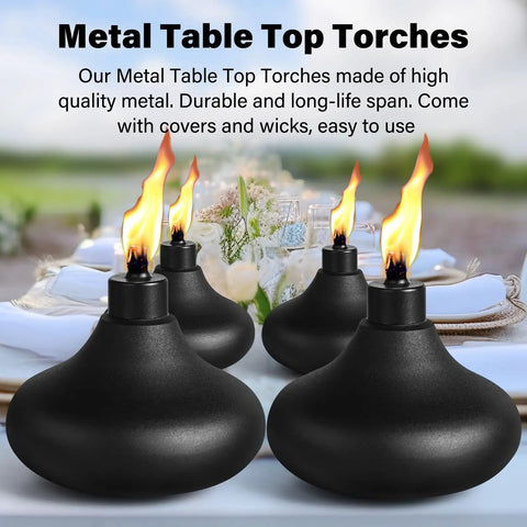 Four metal table top torches with flames lit, placed on an outdoor table, showcasing Two Pack Metal Table Top Torches With 24.5 Ounce Citronella Fuel Capacity Refillable Outdoor Flame Light Lanterns For Patio Deck Garden Party Durable Decorative Torch Lights For Yard Ambience.