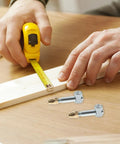 4 Piece 35mm Cabinet Assembly Screw Kit With Invisible Furniture Connectors And Fastening Nuts on wooden board with tape measure