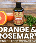 Straight Up Coconut Mct Wood Finishing Oil And Food Safe Cutting Board Sealer on wooden surface with orange and rosemary.