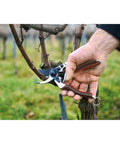 Elite Pruning Shears 8.3 Inch Swiss Made Garden Clippers with Leather Wrapped Handle in use on tree branch.