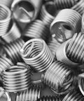 Close-up of 100 Piece 304 Stainless Steel Thread Repair Inserts Kit For M6 Screws M6x1.0x1.5D Wire Sleeve Style Durable Reusable Replacement Repair For Damaged Threads In Metal And Wood Great For DIY Home Projects showing metal coils