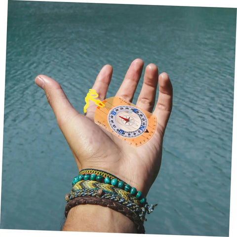 Trail Ready Orienteering Compass Tool With High Precision For Hiking And Camping Luminous Dial In Hand Over Water
