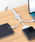 100 Pack Adhesive Cable Clips Clear for Cables Up To 5mm organizing wires on a wooden desk with a phone and laptop.