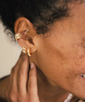 Gold Huggie Hoop Earrings For Women With Chunky Link Chain Cubic Zirconia 14K Gold Plated Hypoallergenic Everyday Jewelry worn on model's ear