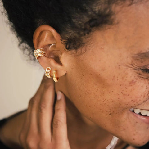 Gold Huggie Hoop Earrings For Women With Chunky Link Chain Cubic Zirconia 14K Gold Plated Hypoallergenic Everyday Jewelry worn on model's ear