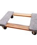 Wooden cart with grey padded surface on four swivel casters for moving equipment and furniture in garage or shop