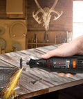 Side view of GOXAWEE rotary tool with black body, grinding metal on a workbench.