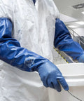 Person wearing full arm 26 inch nitrile safety glove with biodegradable coating, chemical resistant, handling bucket.