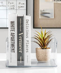 Stackable Open Front Kitchen Storage Bin With Handles Clear Plastic Organizer holding books and a small plant on a white surface