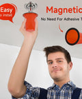 Person installing 15 Pack Fire Sprinkler Covers With Super Strong Magnet orange cap on ceiling, demonstrating easy magnetic installation.