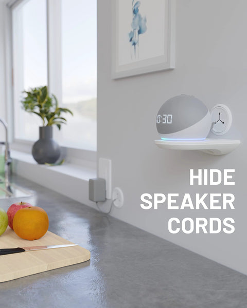 Modern kitchen counter with fruit, wall-mounted speaker, and text reading 'Hide Speaker Cords.'