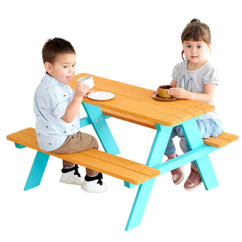 Two children sitting at a Wooden Outdoor Kids Picnic Table And Bench Set In Brown And Aqua, enjoying snacks.