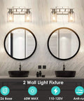Modern Two Light Vanity Light Fixture In Brushed Nickel With Clear Glass Shades Over Mirror in Bathroom Setting