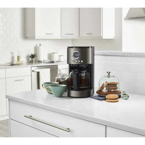 12 Cup Coffee Maker With Glass Carafe, Auto Start 24 Hour Programmable, Drip Free Pour, Black Stainless Finish on kitchen counter