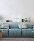 Wall-mounted butterfly decor behind a blue sofa in a modern living room