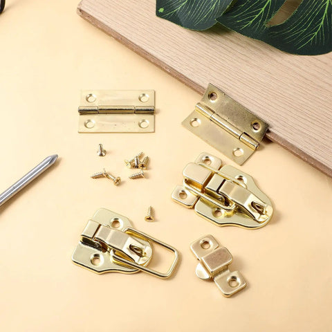 Two Pack Retro Gold Duckbilled Hasp Latch Set With Padlock Hole And Four Hinges Plus Twenty Four Mounting Screws Kit For Wooden Jewelry Boxes Cabinets Toolboxes And Small Chests DIYers Will Approve displayed on a surface with screws and hinges.