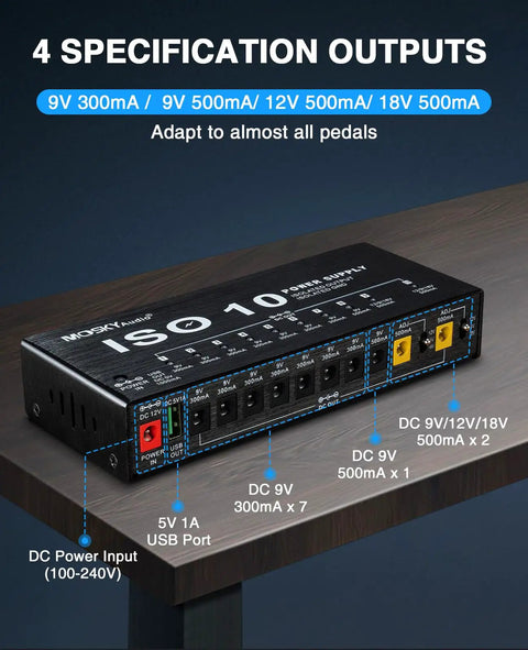 Guitar Pedal Power Supply For Your Rig With 10 Isolated Outputs And USB Port 9V 12V 18V Adjustable Rails on a wooden surface.