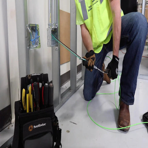 Electrician using THHN 10 AWG Copper Wire Red 100 Ft Roll Indoor Outdoor 600V Rated for power distribution installation