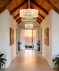 Showstopping Four Lights Drum Crystal Shade Black Chandelier Pendant Light in a bright hallway overlooking sunset