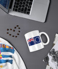 Flat lay of Cook Islands flag 11 oz ceramic mug on desk with laptop, coffee beans, and papers. Flag Of The Cook Islands Coffee Mugs 11 Oz Double Sided Print Mug With Handle Dishwasher Safe Premium Ceramic Awesome Gift For Home Office Coffee Lovers.