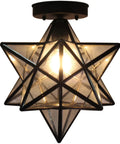 Moravian Star Tiffany Style Clear Glass Ceiling Light With Matte Black Base 12 Inch Shade glowing from below