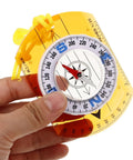 Hand holding Rugged Orange Orienteering Hiking Compass With Lanyard For Hiking Camping And Backpacking Grab And Go No Frills Lightweight Acrylic Navigation Tool With Luminous Pointer Durable Outdoor Survival Gear For Training And Travel