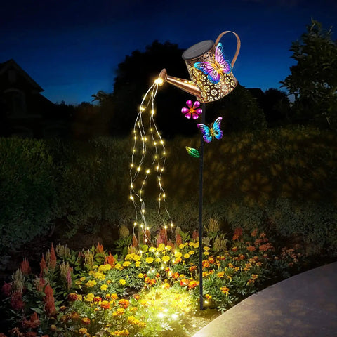 41 Inch Tall Solar Watering Can With LED Lights Garden Stake illuminating garden with butterfly and flower accent at night
