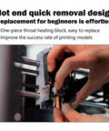Hand demonstrating installation of Upgraded 0.4mm Hotend Kit For Flashforge AD5X Quick Detachable Nozzle Extruder on 3D printer