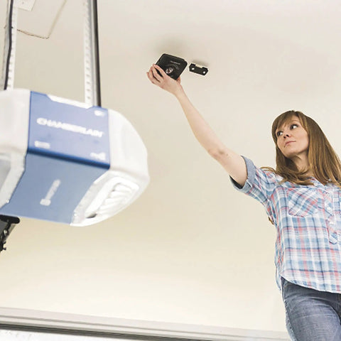 Woman installing MyQ WiFi Smart Garage Door Hub Lets You Open And Close Your Garage Door From Anywhere With Your Phone Real Time Alerts