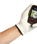 Hand holding Swami Ace Handheld Golf GPS Rangefinder In Orange With Magnetic Case, showing yardages on screen.