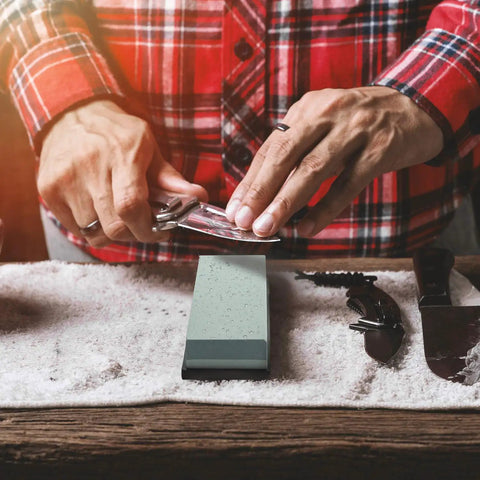Person sharpening knife on Actual Grit Whetstone Set With 400 1000 3000 8000 Grits For Knife Sharpening Pro Grade Silicon Carbide Stone