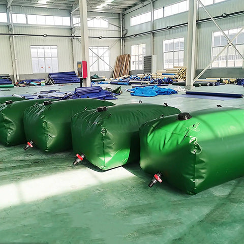 Collapsible Outdoor Water Storage Bag For Garden Farm And Livestock Use, Green PVC Water Bladder Tank, displayed in warehouse