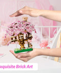 Totally Pink Cherry Blossom Tree Building Set 1113 Pieces For Adults And Kids Sakura Tree House Mini Blocks Kit in hands