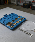 Rock Solid Brass Router Guide Bushing Set With Acrylic Base Plate And Dang Accurate Centering Pin Complete Metric Kit laying in a blue case.