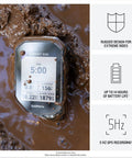 Rugged Mountain Bike GPS Computer With Preloaded Full Color Trail Maps And Advanced Performance Tracking submerged in mud