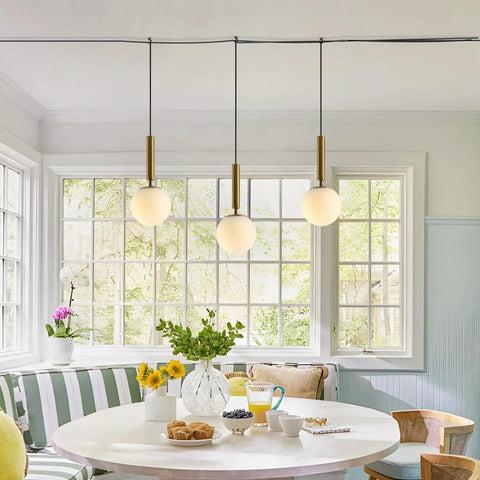 Mid Century Modern Large Gold Globe Pendant Light Plug In With Brushed Brass Finish And White Glass Minimalist Sphere Hanging Lamp Easy Cord Plug In Setup Fourteen Point Seven Six Foot Cord For Flexible Height And Room Essentials shown in dining area.
