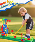 Toddler playing with Toddler Golf Set With Easy Carry Cart, 4 Clubs, 8 Balls, Flags, Holes And Mat Outdoor Mini Golf Kit