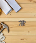 Tools and toad shaped brass cabinet drawer pulls for vintage style retro hardware renovation setup on wood surface