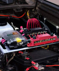 Beefy Power Distribution Block Bus Bar With Four Three Eighths Inch Posts And Six Size Eight Screws 48V DC Max 250 Amp Continuous Pair In Red And Black installed in car engine