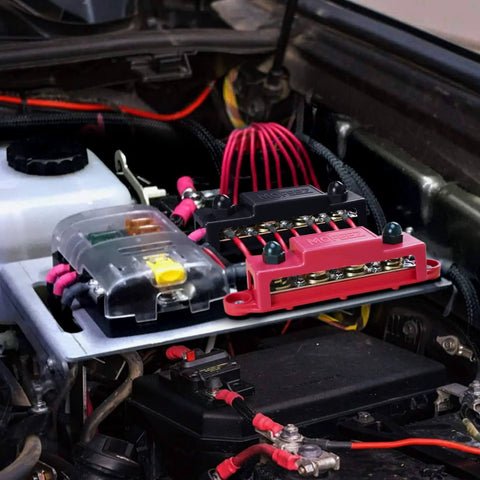 Beefy Power Distribution Block Bus Bar With Four Three Eighths Inch Posts And Six Size Eight Screws 48V DC Max 250 Amp Continuous Pair In Red And Black installed in car engine