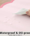 Close-up of Oversized Pink Scalloped Desk Pad For Keyboard And Mouse, 31.5 Inch By 15.7 Inch PU leather showing waterproof checkered pattern.