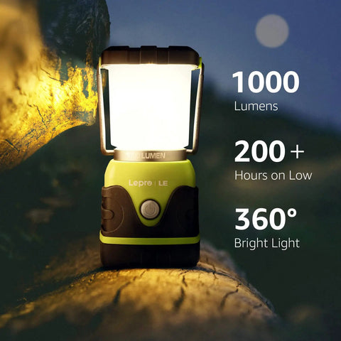 1000 Lumen Battery Powered LED Camping Lantern With Four Light Modes glowing on a log, highlighting 1000 lumens, 200 hours use