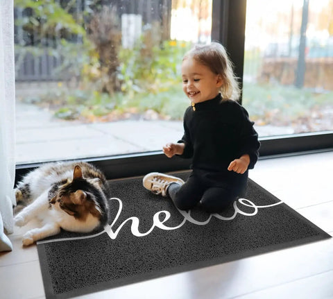 Child and cat on Durable Outdoor Indoor Doormat 30 By 17.5 Inches Non Slip Mud Trapping PVC Silk Loop Mat That Grabs Dirt Without Water Absorption Easy Clean Front Door Mat For Garage Entryway Patio High Traffic Black